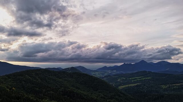 Aerial Hyperlapse Of Fast Moving Clouds Over Mountain Range At Dusk