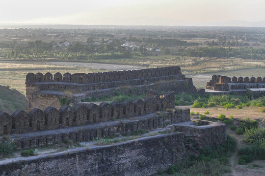 View of the historic stone walls and battlements of Rohtas Fort set against a vast landscape in Dina, Punjab, Pakistan.