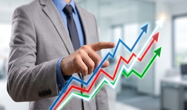 Businessman's hand pointing to upward trending growth charts with bokeh office background