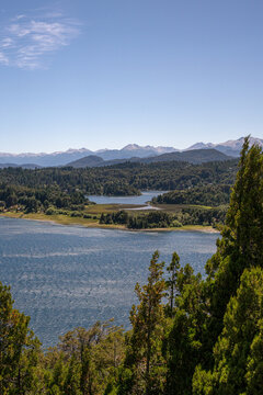 View of Punto Panoramico - Circuito Chico overlooking Nahuel Huapi Lake with dense forests and distant snow-capped Andes mountains in San Carlos de Bariloche, Rio Negro, Argentina.