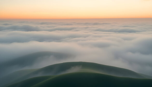 Foggy landscape with layered green hills at sunrise
