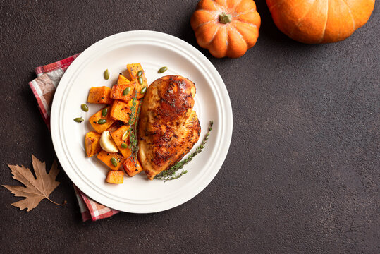 Autumn meal: roasted chicken breast and pumpkin with herbs