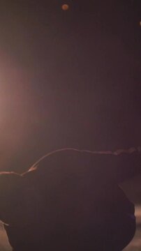 Tricking sport - man performs acrobatic tricks in front of bright sparkles - slow-motion