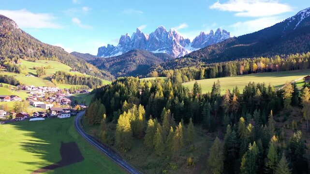 Alpine village and rugged Dolomites peaks in autumn