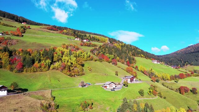 Autumn meadows and farmhouses in the Italian Dolomites