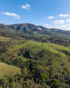 Aerial view of hills in Brazilian countryside under a blue sky