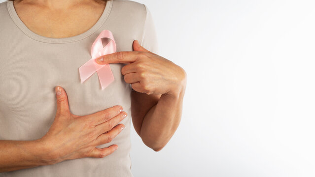 Woman Pointing at Pink Breast Cancer Awareness Ribbon
