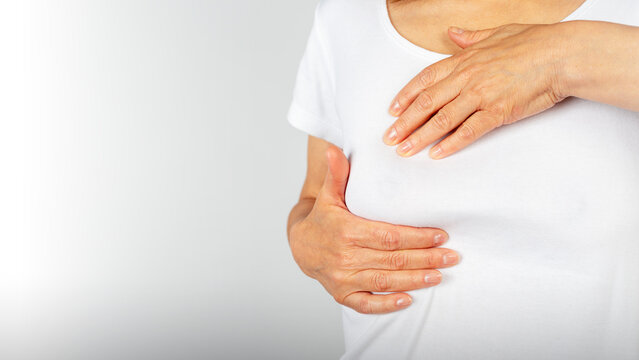 Woman Performing Breast Self-Examination on White Background with Copy-space