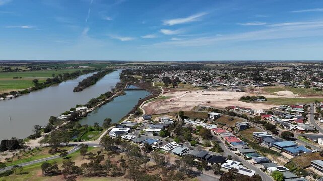 Aerial drone view of the Murray River flowing alongside residential housing estates, new housing subdivisions, and open land releases in Murray Bridge, South Australia