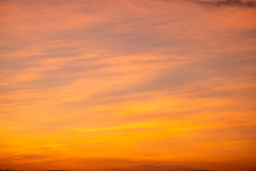 Fototapeta premium Sky sunset,Beautiful sunrise sky with vibrant gradient orange and gold colors and soft blue, Clear atmosphere with wispy clouds. Peaceful, perfect for background and copy space, High resolution images