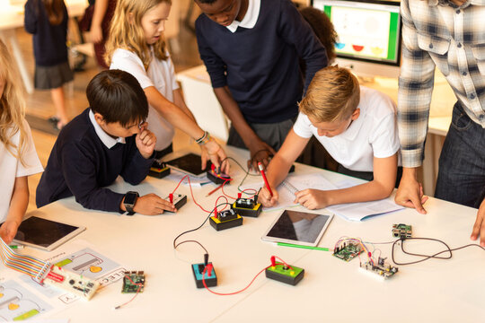 Children engaged in electronics workshop.