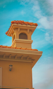 View of an architectural detail featuring a chimney with orange roof tiles against a clear blue sky in Shanghai, Shanghai, China.