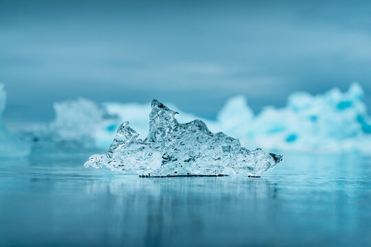 View of a crystalline iceberg fragment resting on the frozen surface of the glacier lagoon near Vatnajokull, Iceland.