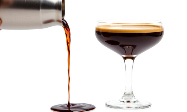 Espresso martini cocktail shaker pouring dark coffee drink into coupe glass on a transparent background