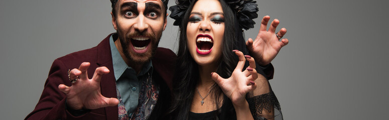 Obraz premium Couple celebrating Halloween joy in diverse costumes at a lively party, banner 