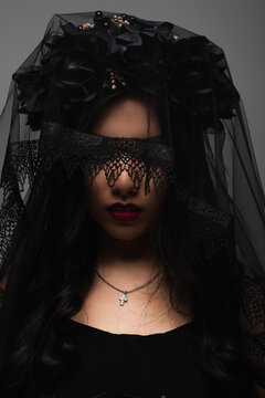 Young Asian woman embodies Halloween spirit in witchy floral adornments