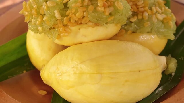 Durian with sweet sticky rice and coconut milk, a Thai dessert on a plate.