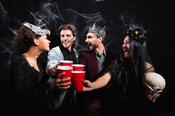 Obraz premium Multicultural friends celebrating Halloween with costumes and joyful spirits