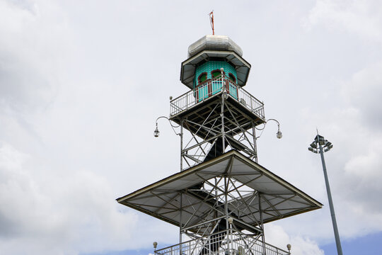 Unique steel minaret tower of Great Mosque of Demak against cloudy sky, Central Java, Indonesia. Famous landmark showcasing historical Islamic architecture, cultural heritage, and religious travel.