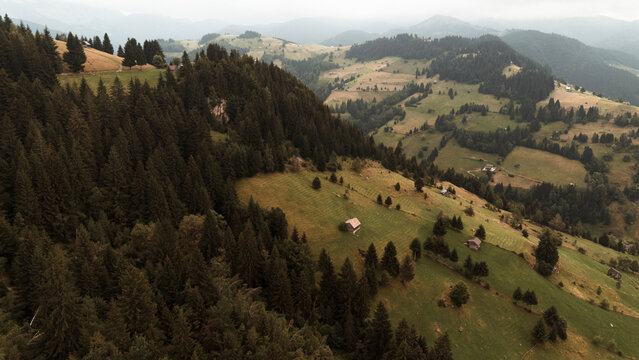 Aerial View of Mountain Meadow with Scattered Cabins - Transylvania, Bucegi Mountains, Romania
