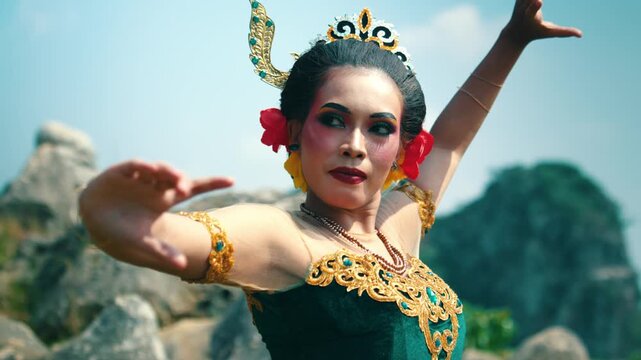 Close-up focusing on the expressive face and intricate hand movements of a Javanese dancer, highlighting the connection between emotion and motion.