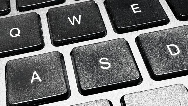Close Up View of Computer Keyboard Keys with Black and Silver Surface