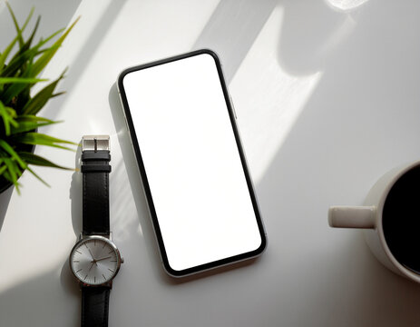 modern blank screen smartphone mockup on a clean white desk, positioned next to an analog wrist watch, a cup of coffee, and a green potted plant with natural window shadows