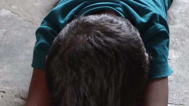 Crying child resting head on arms