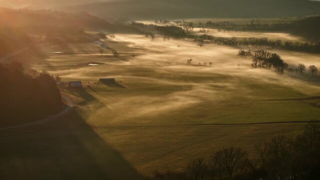 Aerial time lapse of morning fog over farm valley at sunrise, Ozarks
