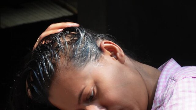 Woman receiving an oil hair treatment
