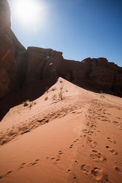 unburst Over Red Sand Dunes and Sandstone Rocks in Wadi Rum Desert, Jordan