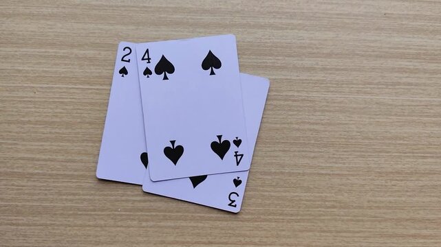 Dealing cards at the table, revealing the poker playing cards.