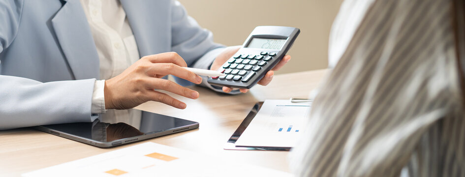 Business meeting, asian group brainstorm analysis on graph data of cost plan. financial consult planning investor asses and present to client, client and advisor review investment strategy in office.