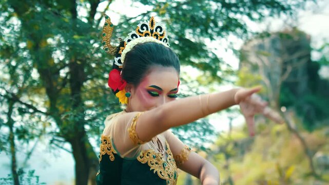 Medium view of a dancer with a playful expression performing quick and intricate hand movements (Jaipong style) in a nature park.