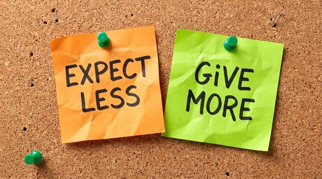 Expect Less Give More message on sticky notes pinned to a cork board