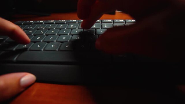 First-person view of a person typing on a computer keyboard at a desk. Concept of productivity, technology, remote work, digital communication, programming, office work, and modern professional lifest