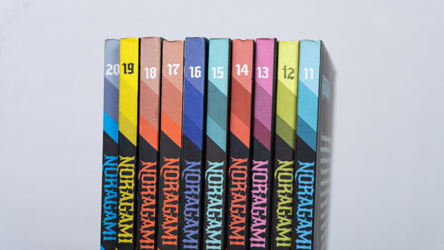 SOUTH KALIMANTAN, INDONESIA - SEPTEMBER 30, 2026: A consecutive sequence of Noragami manga volumes eleven through twenty stands upright against a plain white background. Created by