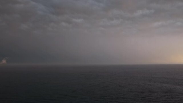 Rain haze and storm clouds over empty Mediterranean horizon
