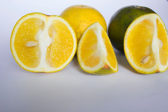 fresh lemon slice, orange slice, jeruk baby, citrus sinensis, green lemon, yellow lemon in white background