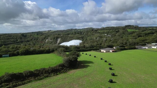St. Blazey, Cornwall, England: DRONE VIEWS: The drone flies towards the Eden Project biomes showing the surrounding countryside. The Eden Project opened in 2001 and is a major UK tourist attraction.
