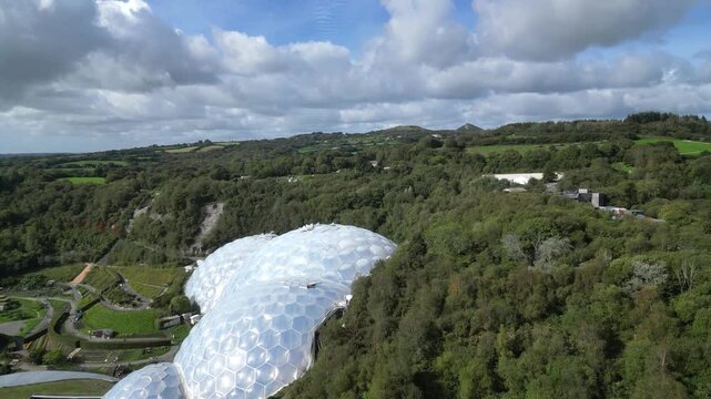 St. Blazey, Cornwall, England: DRONE VIEWS: The drone flies towards the Eden Project biomes showing the surrounding countryside. The Eden Project opened in 2001 and is a major UK tourist attraction.