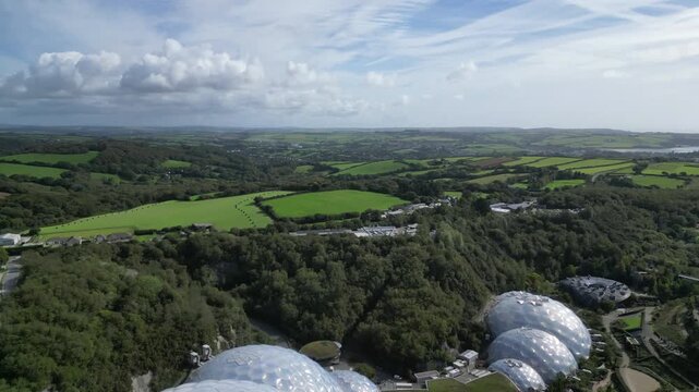 St. Blazey, Cornwall, England: DRONE VIEWS: The drone flies over the Eden Project biomes heading in the direction of Par Sands and the sea. The Project was opened in 2001 and is a major UK attraction.