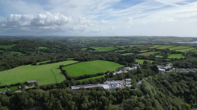 St Blazey, South Cornwall, England: DRONE VIEWS: Looking east from the Eden Project over wrapped hay bales on farmland; Par Sands can be seen (top right). Cornwall is a popular UK holiday destination.