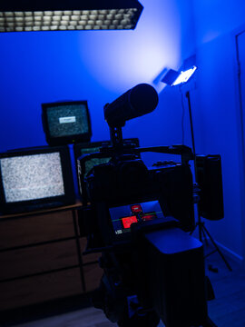 Behind the scenes of video production with mirrorless camera, studio lights and retro television setup for content creation