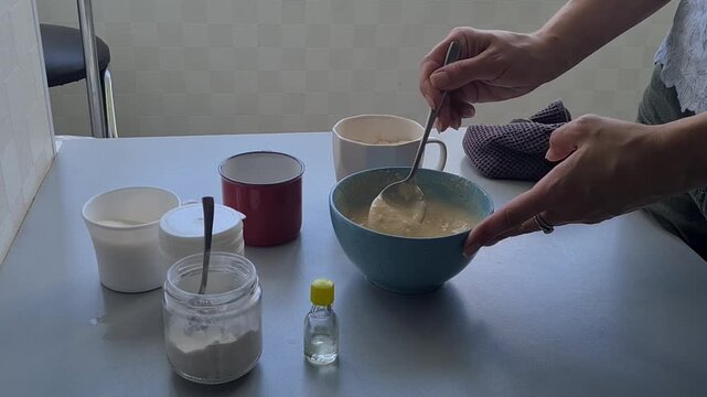 Mixing ingredients in a kitchen to prepare a recipe during daytime