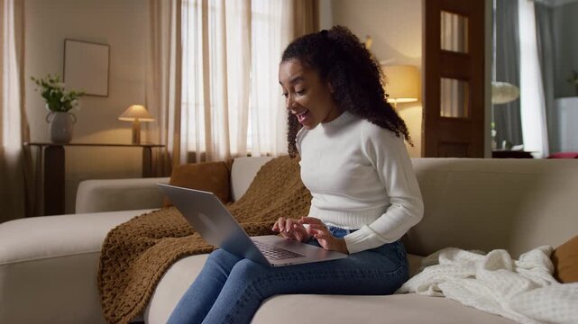 Woman Clapping and Smiling After Reading Good News on Laptop