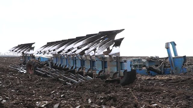 Reversible cultivator. Tractor working on the field doing tillage with cultivator. n