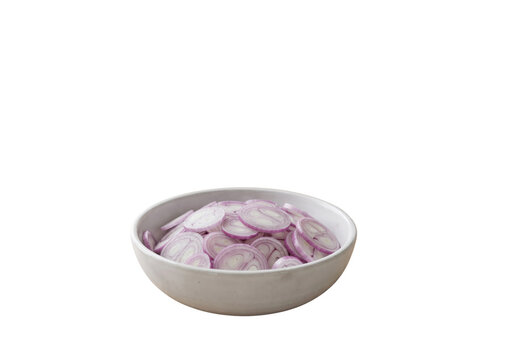 Thin sliced red shallot rings piled in white ceramic bowl isolated on white background, fresh purple onion slices, healthy organic cooking ingredient