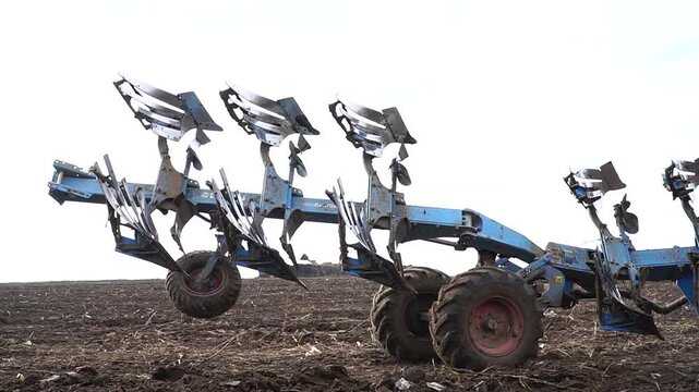 Reversible cultivator. Tractor working on the field doing tillage with cultivator. n