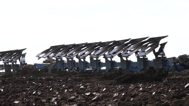 Reversible cultivator. Tractor working on the field doing tillage with cultivator. n
